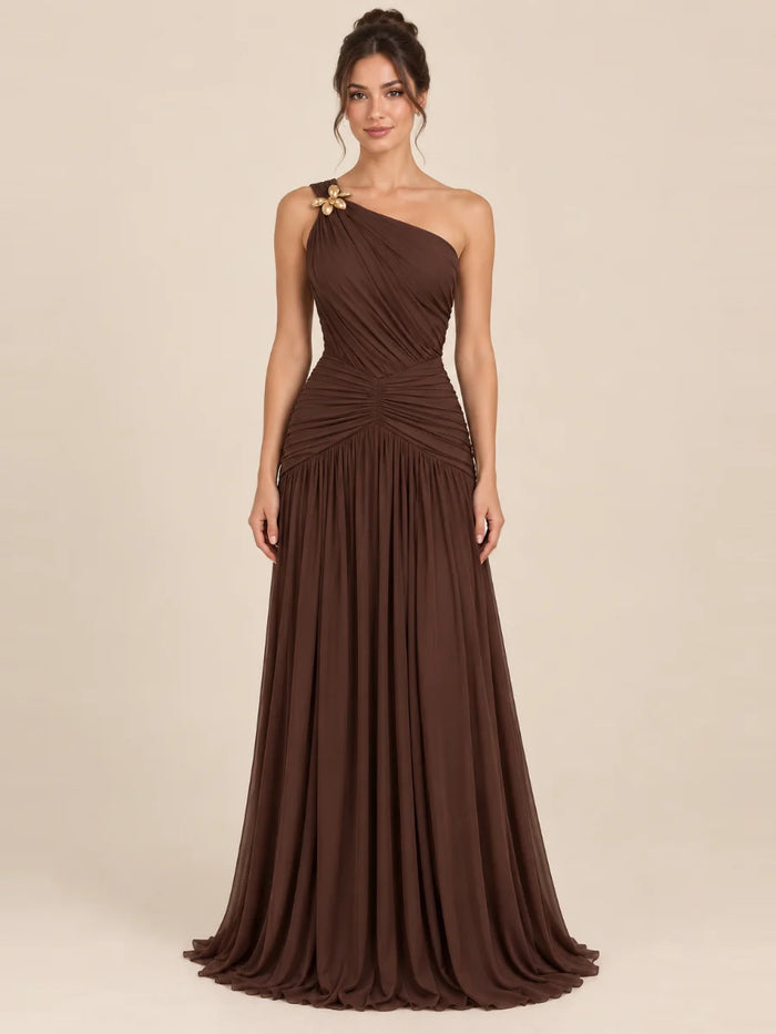 Vestido de grado y fiesta un hombro con flor dorada en color café, nuevo ingreso de la colección 2026 de Casa París en modelo virtual